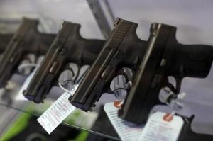 Handguns are seen for sale in a display case at Metro Shooting Supplies in Bridgeton, Missouri, November 13, 2014. REUTERS/Jim Young